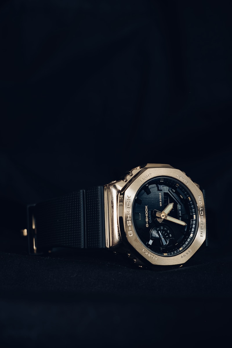 a gold watch on a black background